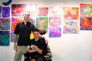  Student in a wheelchair in front of art display